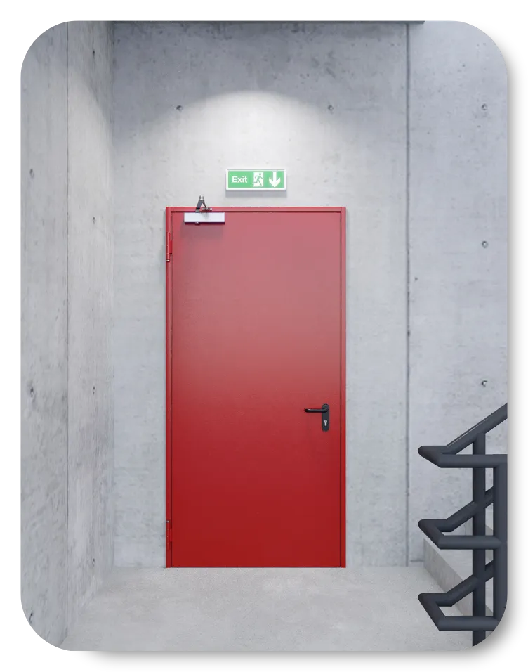 Red emergency exit door in a concrete stairwell with a green illuminated exit sign above it.