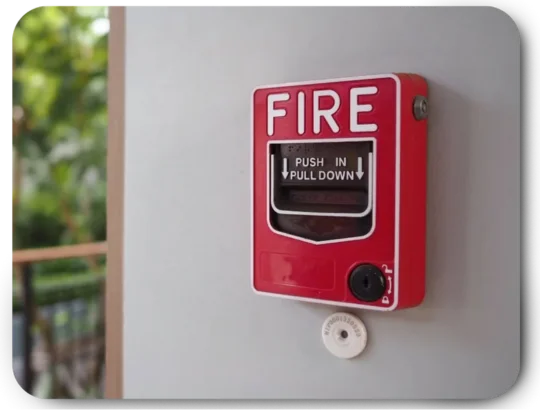 Red fire alarm manual call point on wall for emergency use